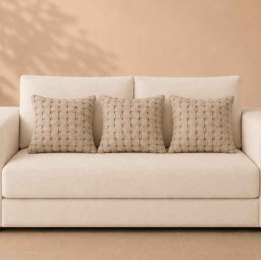 Detail van naturel linnen kussenhoes met brede kruisbinding en zichtbare textuur