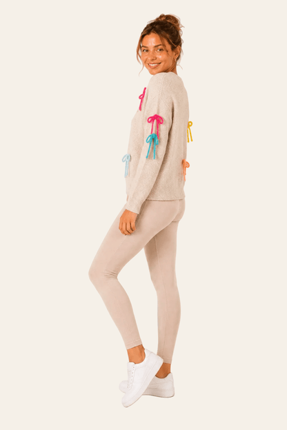 Pull femme à col rond, manches longues et petits nœuds décoratifs colorés