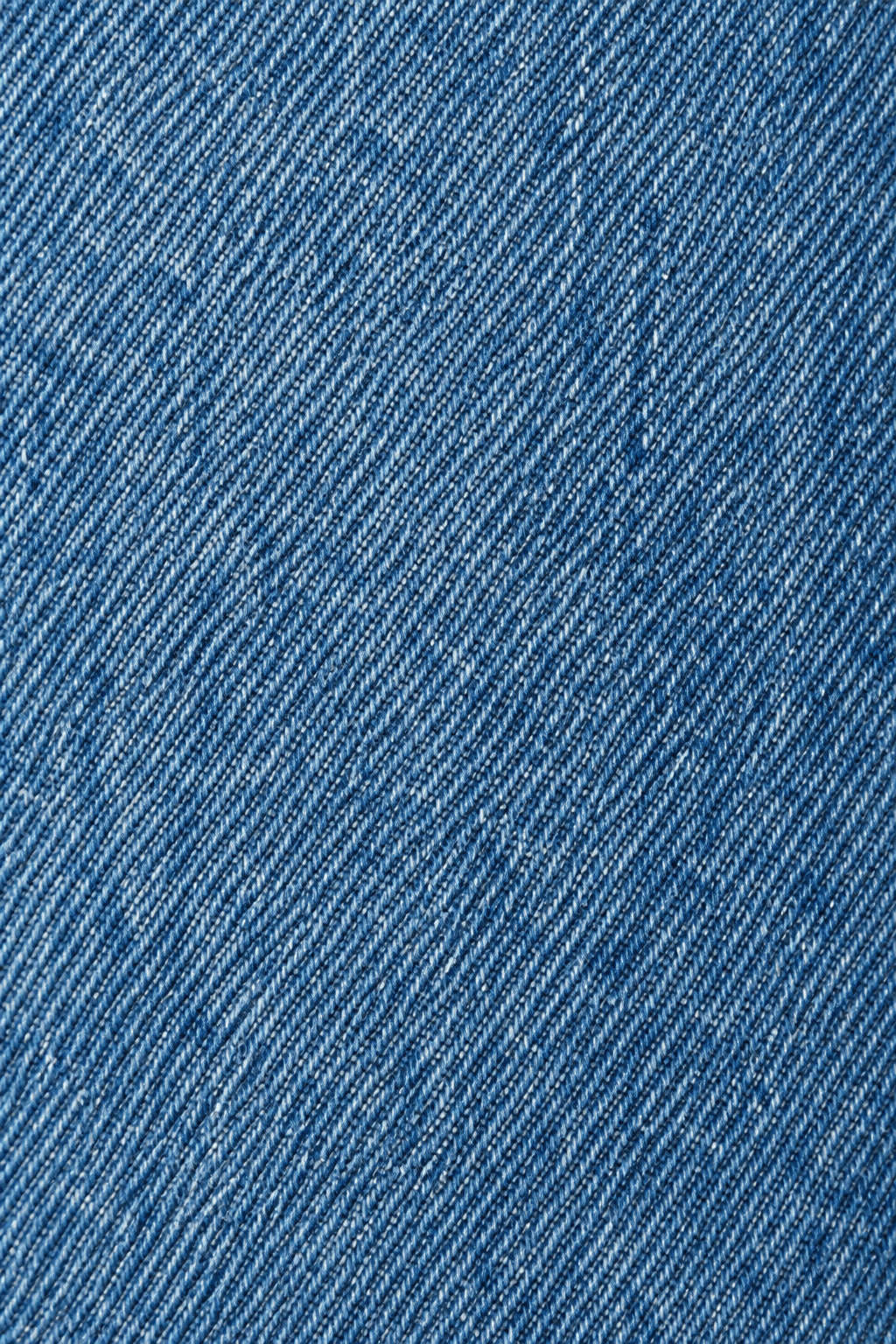 Detail van de denim stofstructuur van relaxed fit damesjeans.