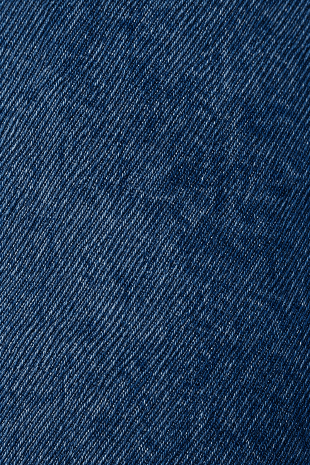 Detail van de stonewash denim stofstructuur van blauwe jeans.
