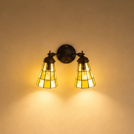 Detail van dubbele Tiffany wandlamp met bruinkleurige glas-in-loodkappen en ronde wandplaat